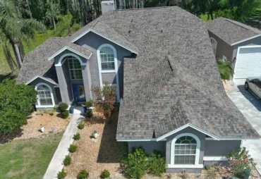 A Titan Roofing crew member on a roof during a storm-restoration job